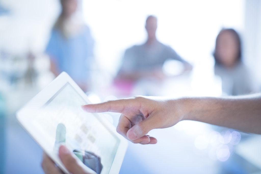 Close up businessman pointing to digital tablet in meeting melanoma staging