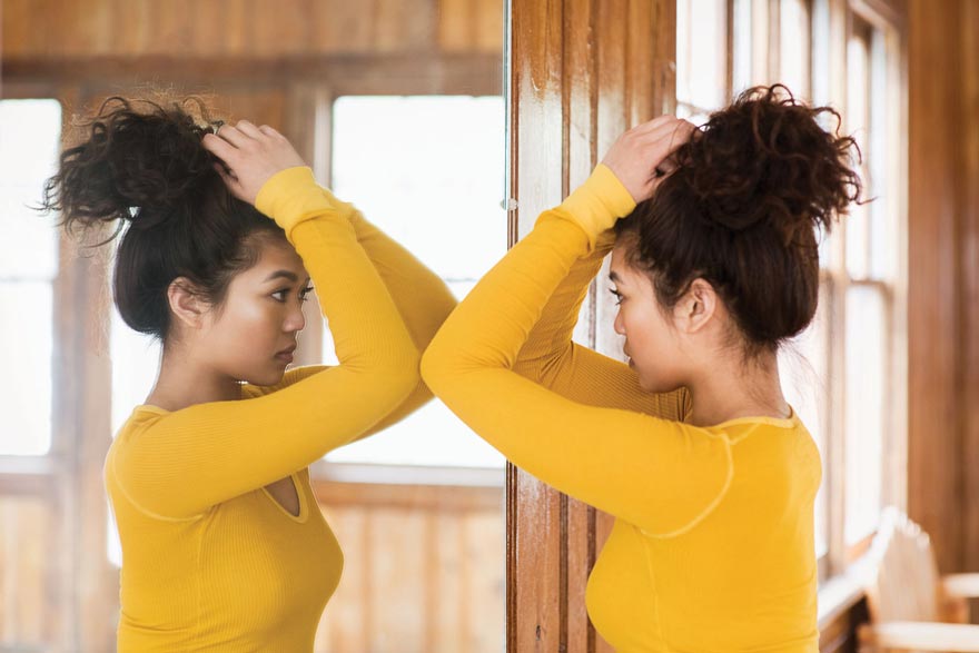 girl looking in the mirror for new changing unusual moles