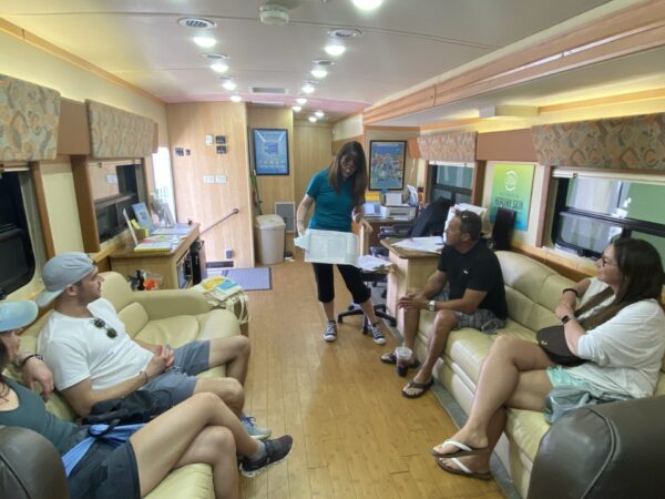 An event manager in Encinitas, CA, explains the screening process to participants while they wait.