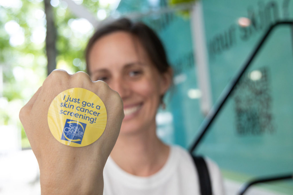 screening sticker on participant hand at Destination Healthy Skin