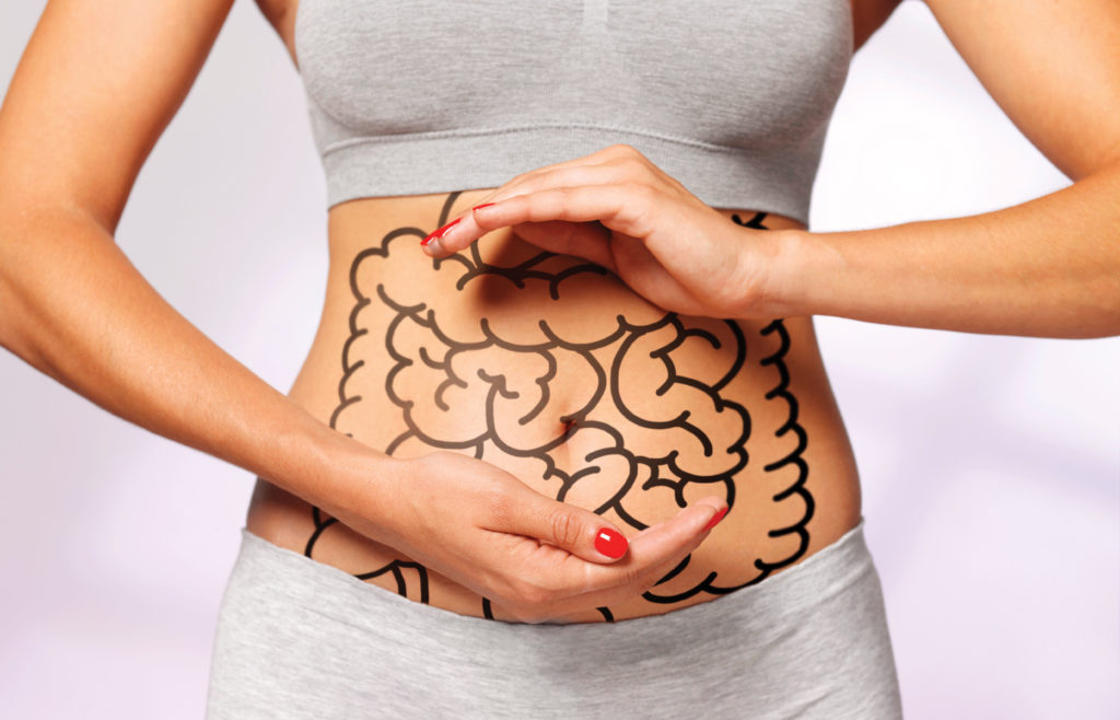 Picture of a woman showing her belly. She has a drawing on it. Skin Cancer Gut